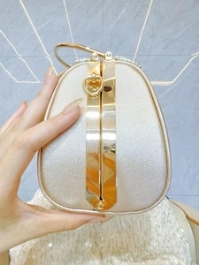 Elegant champagne gold evening clutch bag with diamond trim and circular handle