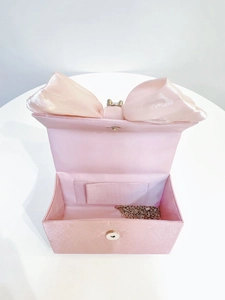Internal view of pink satin evening clutch bag with magnetic clasp and chain strap