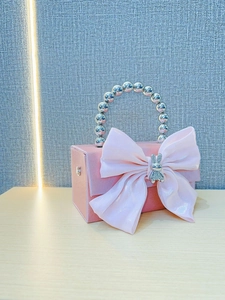 Pink satin evening clutch with large bow, glittery rabbit charm and silver bead handle