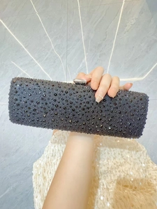 Close-up of a sparkling black rhinestone evening clutch bag with elegant silver clasp