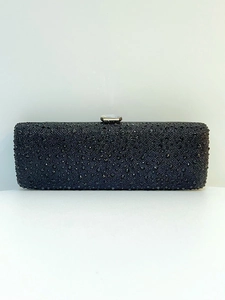 Close-up of luxury black evening clutch bag with sparkling rhinestones and silver metal clasp