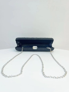 Open black shimmering evening clutch with rhinestone buckle and silver chain