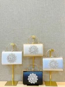 Elegant rhinestone dinner clutches in white, gold, silver, and black with metal ring handles