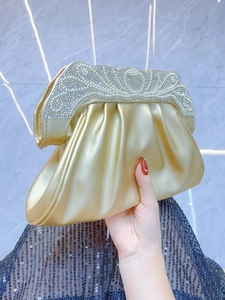 Elegant gold pleated evening clutch bag with sparkling rhinestone wave edge for parties