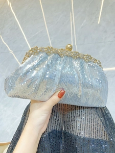 Detail of silver-blue sequin evening clutch with crystal floral trim and gold-tone clasp