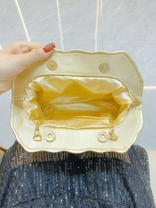 Golden wave evening clutch bag with chain strap and satin interior for party and banquet