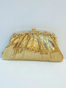 Detail of gold sequin evening clutch bag with rhinestone floral clasp and metal frame