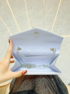 Elegant silver glitter evening clutch bag with chain strap and magnetic flap closure