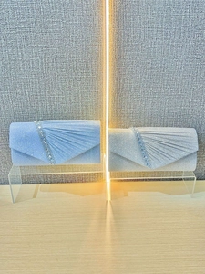 Elegant evening clutch bags in silver and blue with pleat detail and rhinestone trim