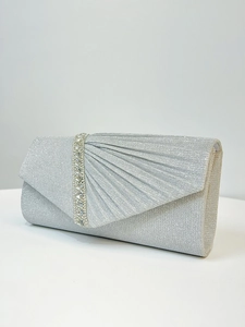 Detailed view of silver glitter clutch bag featuring scallop pleats and rhinestone inlay