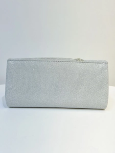 Detailed macro of silver glitter evening clutch bag with rhinestone metal clasp
