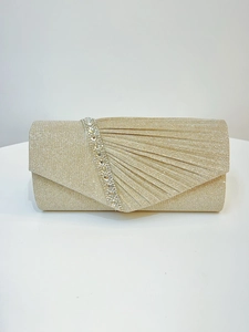 Close-up of champagne gold evening clutch with fan-shaped pleats and rhinestone trim