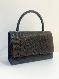 Macro shot of elegant black sequin evening clutch bag with glittery handle and box design