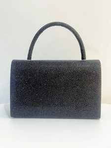Close-up of black glitter evening bag featuring a metallic handle and sparkling texture
