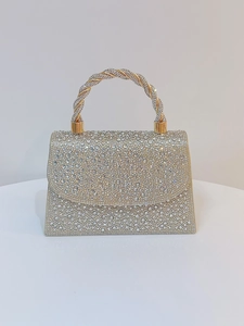 Macro shot of silver rhinestone crystals and metallic twisted handle on luxury evening bag