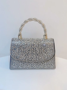 Detailed macro of silver rhinestone evening bag with luxury crystal twisted handle