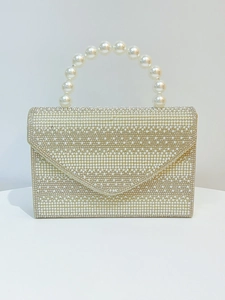 Detailed view of pearl-embellished evening clutch bag with elegant bead handle