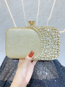 Detail of evening clutch with gold glitter, sparkling rhinestones and crystal clasp