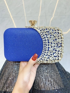 Detailed close-up of royal blue evening clutch with rhinestones and gold buckle