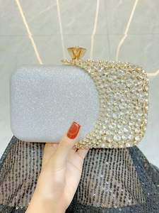 Close-up of a silver glitter evening clutch bag with sparkling rhinestone embellishments