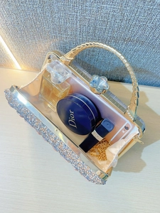 Macro view of crystal evening bag interior showing capacity for perfume and lipstick