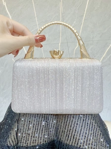 Detail of evening clutch with silver rhinestones, gold bamboo handle and crystal clasp
