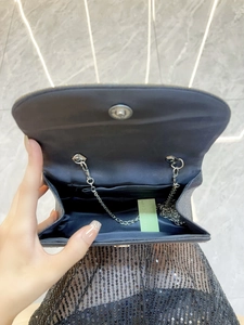 Elegant black rhinestone evening bag with silver chain strap and spacious interior