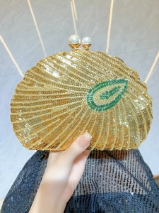 Detail of beaded peacock pattern evening clutch with gold sequins and pearls
