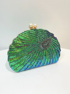 Detailed view of beaded shell clutch featuring green gradient sequins and pearl clasp
