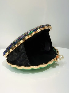 Detail of shell-shaped evening clutch with colorful beads and pearl clasp
