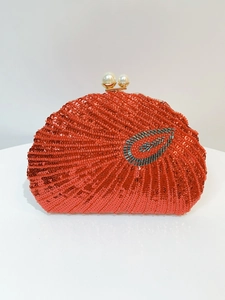 Detail of red sequin evening bag with leaf ornaments and twin pearl clasp closure
