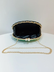 Top view of green shell-shaped beaded evening bag with pearl clasp and gold chain