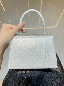 Détail du sac de soirée argenté à paillettes avec garniture en strass et poignée