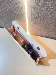 Interior view of pink evening clutch bag showing capacity for phone and cosmetics