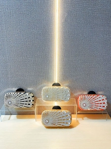Elegant rhinestone evening clutch bag with sunburst pattern in gold, black, and red colors