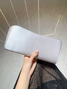 Macro shot of silver evening clutch bag with pearlescent shimmer and rounded corners