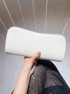 Close-up of a white rectangular evening clutch bag in premium faux leather finish