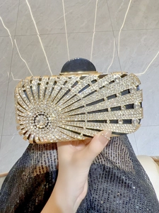 Detailed macro of a gold rhinestone evening clutch bag with sparkling sunburst pattern