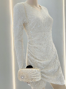 Detail of evening clutch featuring champagne crystals, pearls, and a gold chain strap