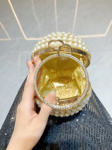 Elegant round pearl evening clutch with gold handles and detachable chain strap