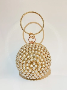 Macro detail of sphere evening bag with faux pearls, rhinestones and metal ring handle