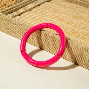 Vibrant hot pink bamboo-style stretch bracelet with polished tubular resin links