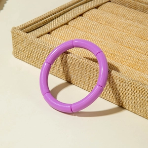 Close-up of a purple segment bamboo-style acrylic stretch bracelet on display