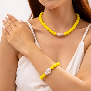 Détail d'un ensemble de collier et bracelet en perles jaunes avec accents de perles baroques