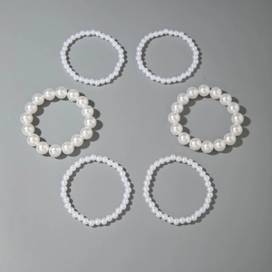 Detailed view of 6-piece white faux pearl beaded stretch bracelet set with glossy finish