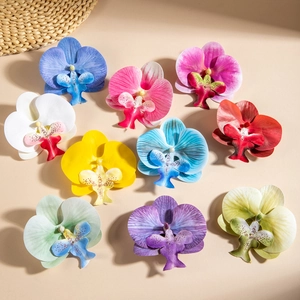 Close-up of colorful artificial orchid flower heads with realistic silk fabric texture