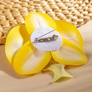 Detail of yellow phalaenopsis orchid brooch back with silver pin and felt base