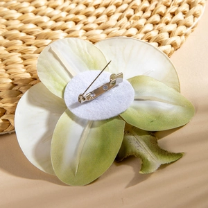 Close-up of the metal pin and felt backing on a realistic orchid flower brooch