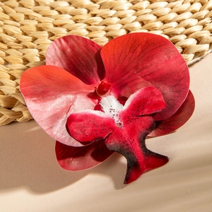 Close-up of deep red artificial orchid flower head with detailed bionic textures