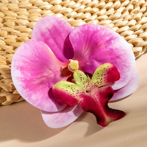 Macro detail of artificial phalaenopsis orchid bloom with pink gradient petals